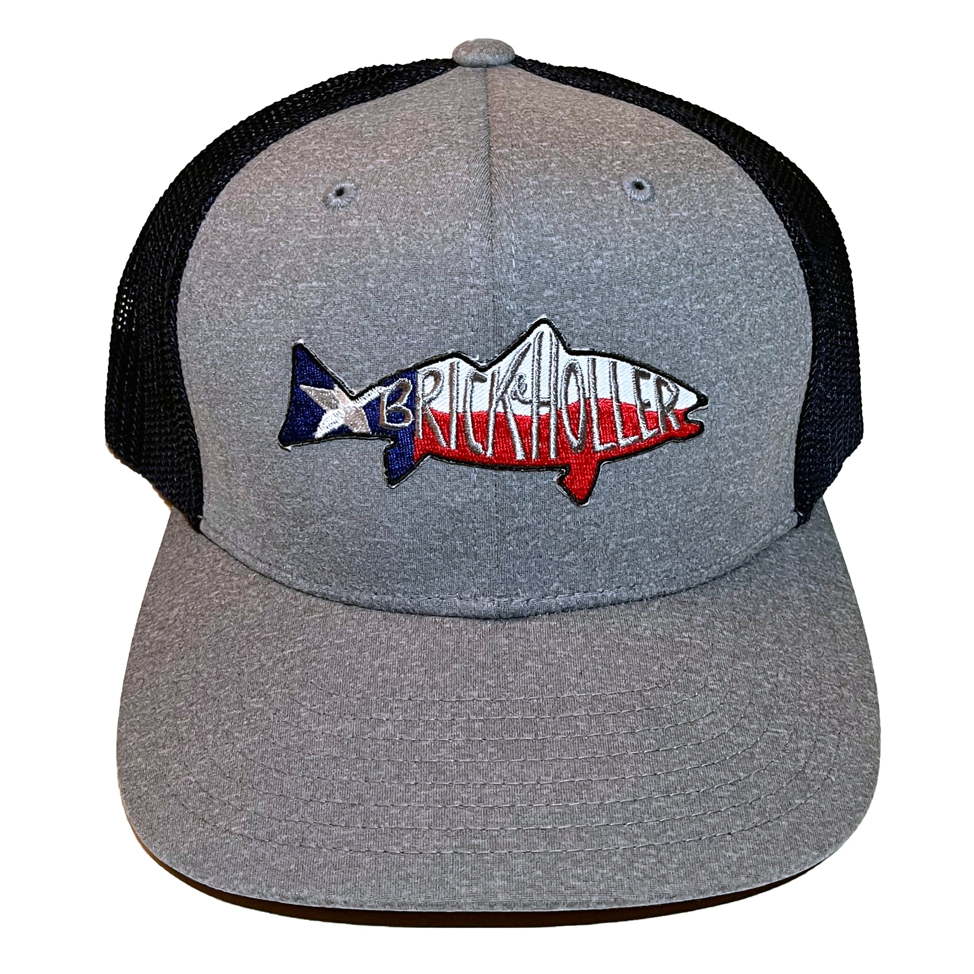 Gray front, black back ball cap with fish patch containing "Brick & Holler" over portion of Texas flag photographed in studio on white.